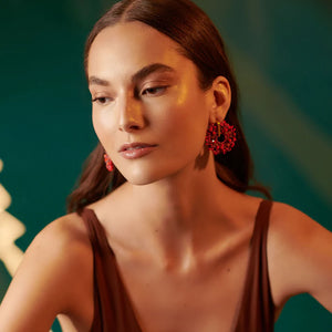lady with a pair of red earrings